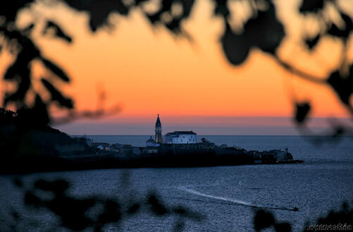 An evening sky behind a church by the sea (a photograph).