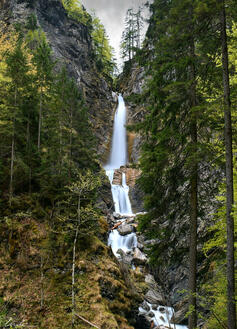 A waterfall in Gozd Martuljek (photograph).